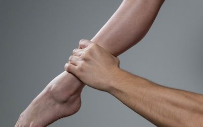 Close-up on a person's hands during a strength pose.
